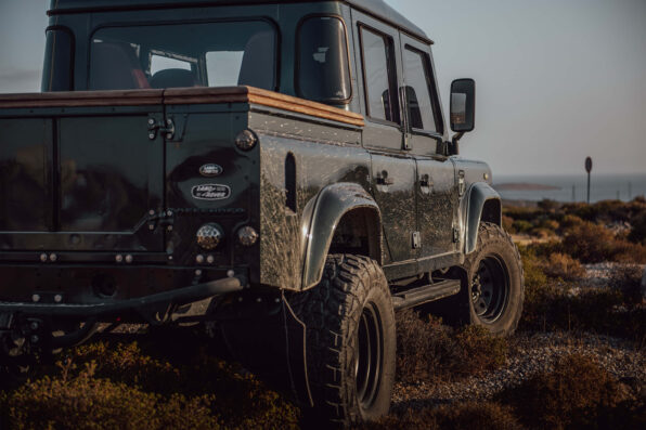 land rover defender back view desert