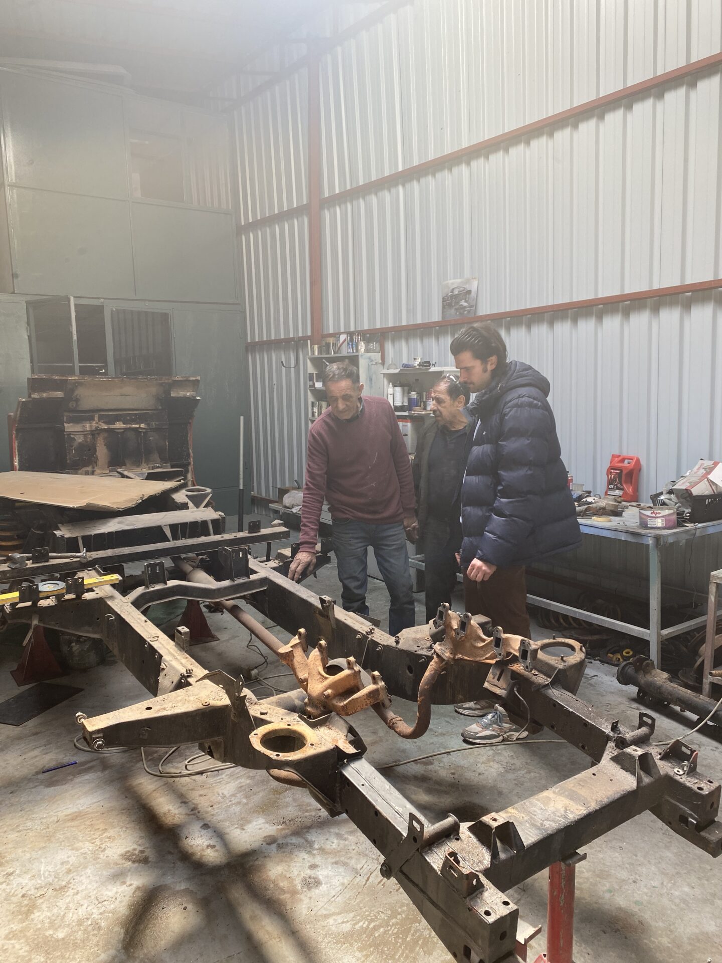 Land Rover Defender 110 Stripped Chassis being inspected at Phoenix restorations facility