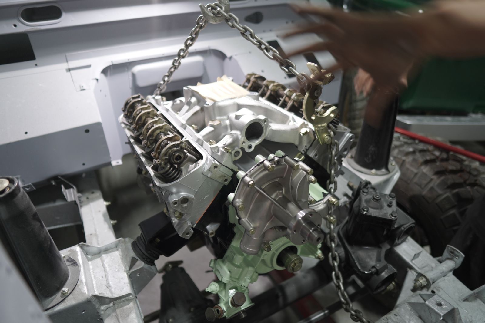 3.5L V8 engine block on chains being attached to a chassis
