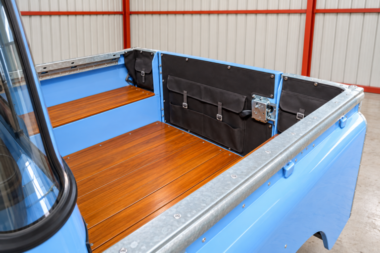 Teak cargo bed and storage pockets